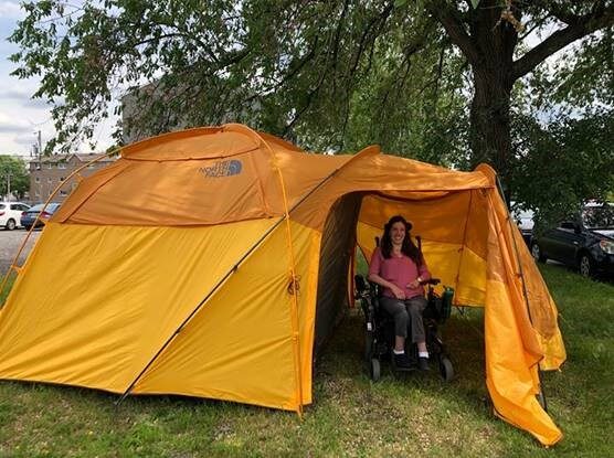 Portrait d'une personne en chaise roulante dans une tente